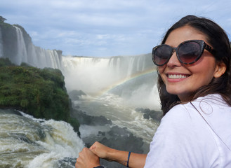 Beautiful young women posing at Iguazu Falls, Argentina