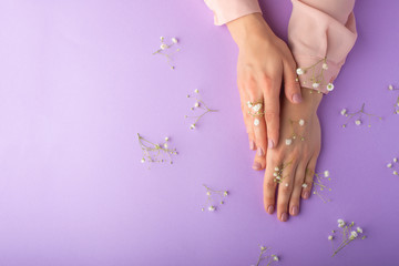 Fototapeta premium female well-groomed hands with white delicate flowers