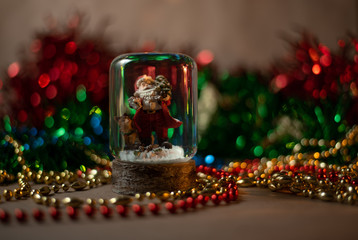 Santa Claus in a glass ball. Christmas mood. Greeting card.