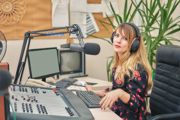 Radio DJ announces news in a radio studio