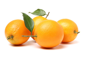 orange fruit with leaves on white background.