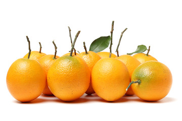 orange fruit with leaves on white background.