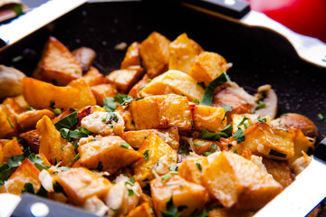 Fried meat in a frying pan closeup. Top view with copy space