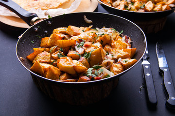 Fried meat in a frying pan closeup. Top view with copy space