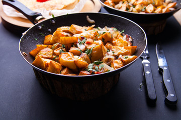 Fried meat in a frying pan closeup. Top view with copy space