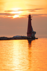 Fototapeta premium lighthouse at sunset in winter 