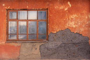 Window in house. An old wooden window on an old peeling wall.