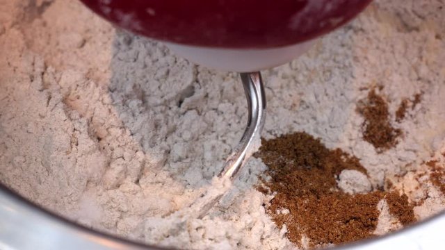 Preparation of homemade bread - Kitchen mixer stirs dry mix on dough for bread
