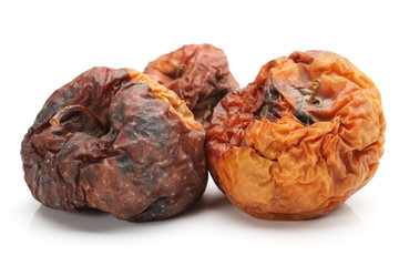 Badly rotten apple on a white background.