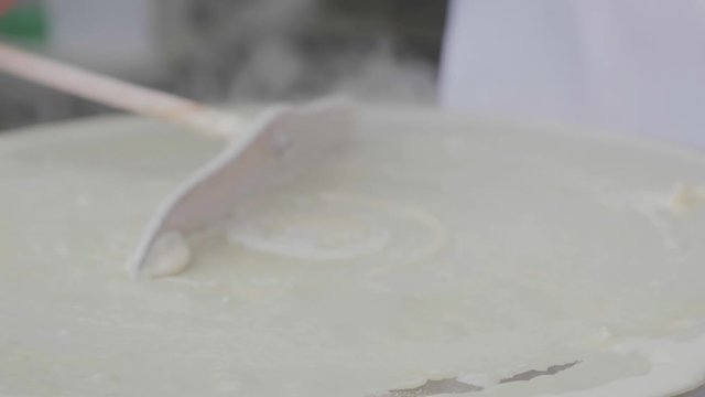 Close-up shot of a traditional cr&ecirc;pe being prepared. 