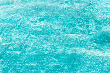 Light blue acrylic paint texture with small stokes on white see through paper.