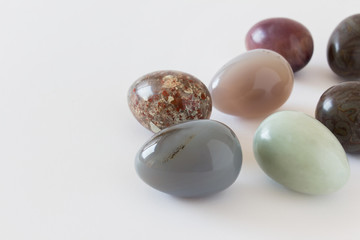 Beautiful decorative Easter eggs made of glossy polished precious opal stones colored in dark brown...