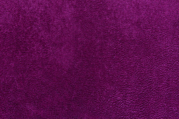 Texture of fluffy fabric cloth colored with dark magenta pink.
