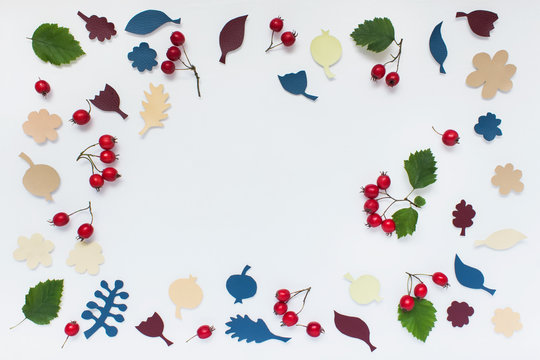 Autumn thanksgiving pattern with hand cut fabric craft yellow blue red plant leaves, apples silhouettes on white backgound. Photo with copy blank space.
