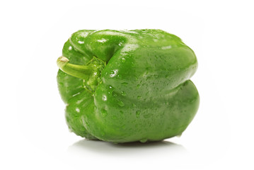 Ripe sweet pepper of a green color on a white background.