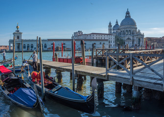 Fototapeta na wymiar Gondolas on Canal Grande with Basilica di Santa Maria della Salute in the background in Venice, Italy