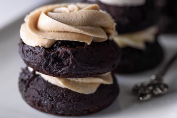 Chocolate cupcakes with various flavours of whipped cream