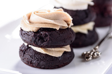 Chocolate cupcakes with various flavours of whipped cream