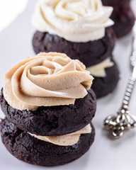 Chocolate cupcakes with various flavours of whipped cream