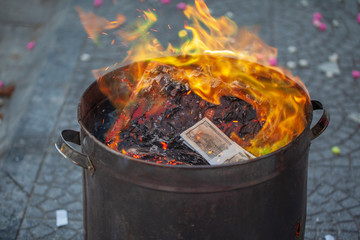 Financial concept, dollars banknotes burn in a barrel, Burning money - 100 american dollar...