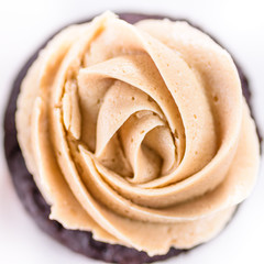 Chocolate cupcakes with various flavours of whipped cream