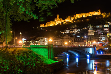 Fototapeta na wymiar Night view of Metekhi bridge and Narikala fortress in Tbilisi