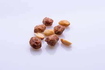 Peanuts praline sweet on dark grey background, top view, soft light, copy space