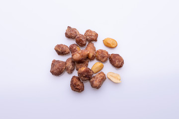 Peanuts praline sweet on dark grey background, top view, soft light, copy space