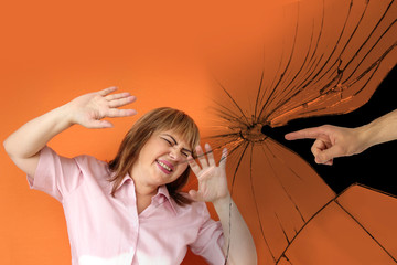 male hand against a background of broken glass shows an accusing gesture at a woman who threw up...