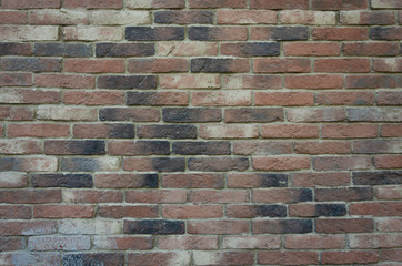 Old brick wall.Masonry of colored bricks.