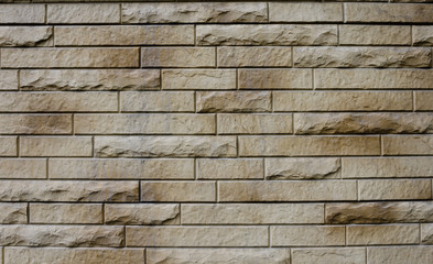 The wall is made of brick and natural stone.