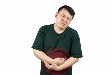 Asian man suffering from terrible stomachache, hand touching belly isolated on white background....