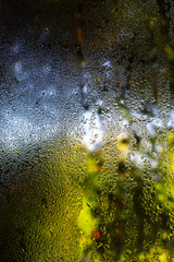 Rain drops, Water drops on mirror window in bokeh green garden background, Selective focus, About Morning, Rainy day concept