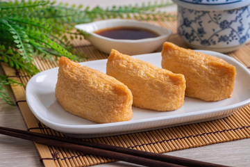 Fototapeta na wymiar Rice ball wrapped in deep fried tofu pouches (Inari Sushi), Japanese food