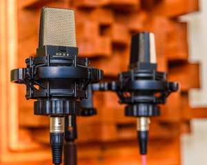 A pair of microphones on a stereo bar in a OTRF stereo pattern for recording a drum room with shallow depth of field