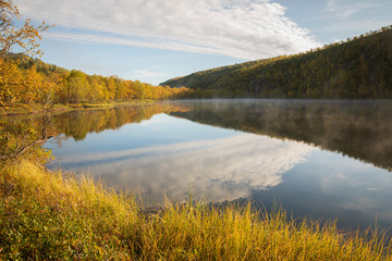 Wilderness lake decorated by fall colors