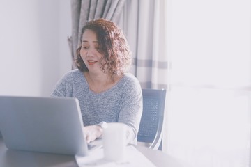 senior woman working on laptop at home