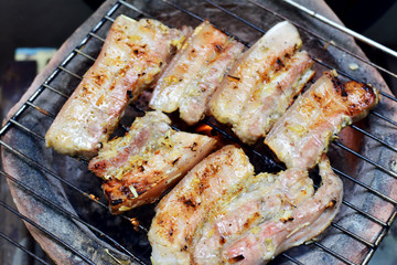 Streaky pork on a charcoal grill