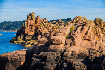 Fototapeta na wymiar Granite pink boulders near Plumanach. The coast of Pink Granite is a unique place in Brittany. France