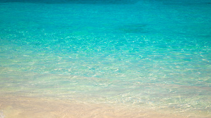 sandy beach and blue sea wave. Beautiful natural background. Tourism and travel.