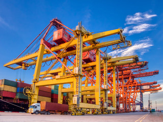 The container vessel during discharging at an industrial port and move containers to container yard...