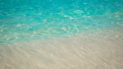 sandy beach and blue sea wave. Beautiful natural background. Tourism and travel.