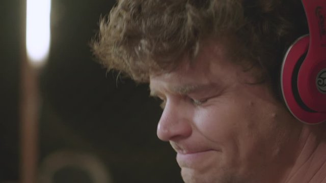 Close Up Of A Man Bobbing His Head While Listening To Music