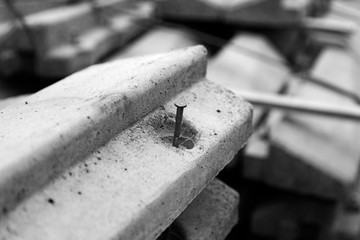 concrete blocks located in a pile, the top of the terminals has a hole with a nail in it