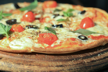 Anchovy think yummy pizza, Italian famous dish with salty fish, black olive, red cherry tomoto, permesan cheese and origano as ingredient