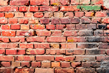 Fototapeta premium Texture of a brick wall with cracks and scratches which can be used as a background