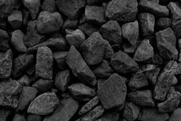 Natural fire ashes with dark grey black coals texture. It is a flammable black hard rock. Space for text.