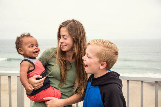 Diverse Group Of Children Laughing Together And Playing Together Outdoors. A Group Of Cute Kids Having Fun And Smiling