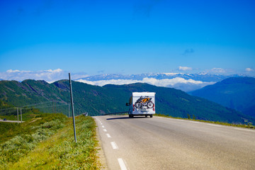 Camper car with bicycles on road