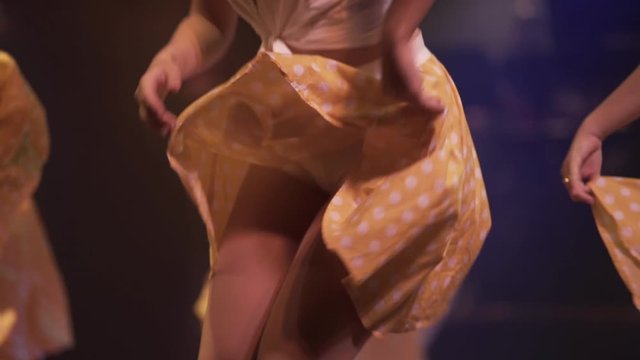 girls dancers dancing joyfully with yellow skirts at Cuba, exotic dancers close up